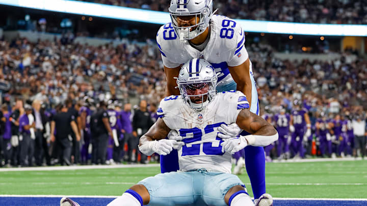 Dallas Cowboys running back Rico Dowdle is helped up by tight end Brevyn Spann-Ford against the Baltimore Ravens.