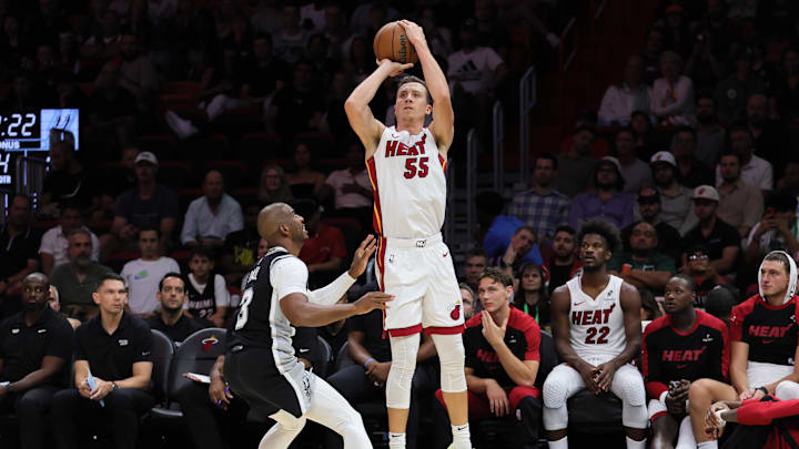 Oct 15, 2024; Miami, Florida, USA; Miami Heat forward Duncan Robinson (55) shoots the basketball over San Antonio Spurs guard Chris Paul (3) during the fourth quarter at Kaseya Center. Mandatory Credit: Sam Navarro-Imagn Images