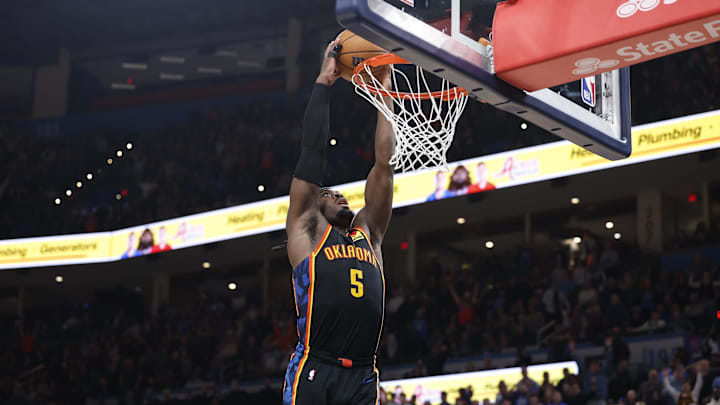 Jan 5, 2025; Oklahoma City, Oklahoma, USA; Oklahoma City Thunder guard Luguentz Dort (5) dunks against the Boston Celtics during the fourth quarter at Paycom Center. Mandatory Credit: Alonzo Adams-Imagn Images