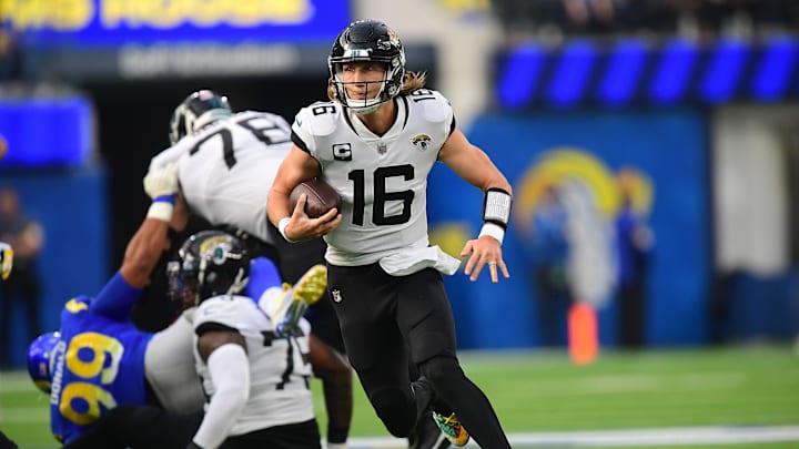 Dec 5, 2021; Inglewood, California, USA; Jacksonville Jaguars quarterback Trevor Lawrence (16) runs the ball against the Los Angeles Rams during the first half at SoFi Stadium. Mandatory Credit: Gary A. Vasquez-Imagn Images