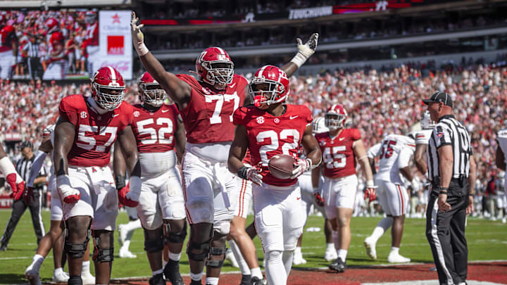 Oct 12, 2024; Tuscaloosa, Alabama, USA; Alabama Crimson Tide offensive lineman Jaeden Roberts (77) and his teammates react after Alabama Crimson Tide running back Justice Haynes (22) scores a touchdown agains the South Carolina Gamecocks during the second quarter at Bryant-Denny Stadium. Mandatory Credit: Will McLelland-Imagn Images