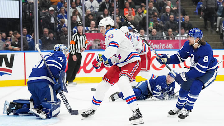 Oct 19, 2024; Toronto, Ontario, CAN; New York Rangers center Matt Rempe (73) battles in front of the net with Toronto Maple Leafs defenseman Chris Tanev (8) during the second period at Scotiabank Arena. Mandatory Credit: Nick Turchiaro-Imagn Images