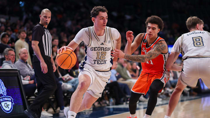 Jan 6, 2026; Atlanta, Georgia, USA; Georgia Tech Yellow Jackets guard Kam Craft (12) drives past Syracuse Orange guard Naithan George (11) in the second half at McCamish Pavilion. Mandatory Credit: Brett Davis-Imagn Images
