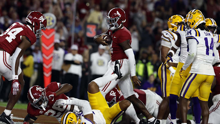 Nov 4, 2023; Tuscaloosa, Alabama, USA; Alabama Crimson Tide quarterback Jalen Milroe (4) carries the ball in for a touchdown against the LSU Tigers during the first half at Bryant-Denny Stadium. Mandatory Credit: Butch Dill-Imagn Images