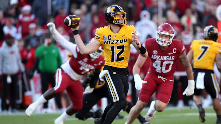 Nov 24, 2023; Fayetteville, Arkansas, USA; Missouri Tigers quarterback Brady Cook (12) passes the