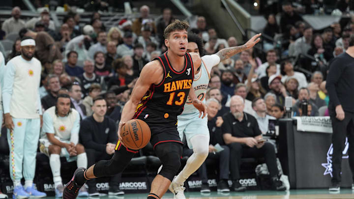 Dec 19, 2024; San Antonio, Texas, USA; Atlanta Hawks guard Bogdan Bogdanovic (13) dribbles past San Antonio Spurs forward Julian Champagnie (30) in the second half at Frost Bank Center. Mandatory Credit: Daniel Dunn-Imagn Images Dec 19, 2024; San Antonio, Texas, USA; Atlanta Hawks guard Bogdan Bogdanovic (13) dribbles past San Antonio Spurs forward Julian Champagnie (30) in the second half at Frost Bank Center. Mandatory Credit: Daniel Dunn-Imagn Images