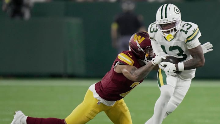 Green Bay Packers wide receiver Dontayvion Wicks (13) makes a catch for a first down while covered by Washington Commanders cornerback Marshon Lattimore (2) during the first quarter of their game Thursday, September 11, 2025 at Lambeau Field in Green Bay, Wisconsin.