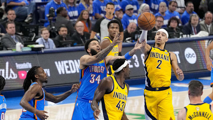 Jun 8, 2025; Oklahoma City, Oklahoma, USA; Oklahoma City Thunder forward Kenrich Williams (34) and Indiana Pacers guard Andrew Nembhard (2) battle for the loose ball during the second quarter of game two of the 2025 NBA Finals at Paycom Center. Mandatory Credit: Kyle Terada-Imagn Images