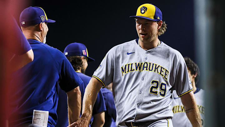 Aug 15, 2025; Cincinnati, Ohio, USA; Milwaukee Brewers relief pitcher Trevor Megill (29) high fives teammates after the victory over the Cincinnati Reds at Great American Ball Park. Mandatory Credit: Katie Stratman-Imagn Images