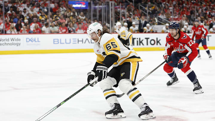 Nov 8, 2024; Washington, District of Columbia, USA; Pittsburgh Penguins defenseman Erik Karlsson (65) skates with the puck as Washington Capitals right wing Brandon Duhaime (22) chases in the third period at Capital One Arena. Mandatory Credit: Geoff Burke-Imagn Images