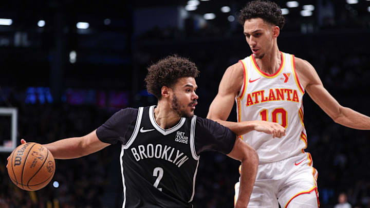 Mar 16, 2025; Brooklyn, New York, USA; Brooklyn Nets forward Cameron Johnson (2) is defended by Atlanta Hawks forward Zaccharie Risacher (10) during the second half at Barclays Center. Mandatory Credit: Vincent Carchietta-Imagn Images