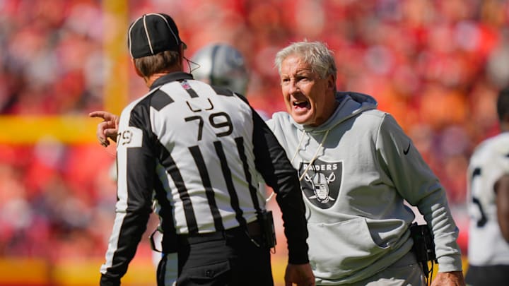 Oct 19, 2025; Kansas City, Missouri, USA; Las Vegas Raiders head coach Pete Carroll speaks to line judge Kent Payne (79) after a play against the Kansas City Chiefs during the third quarter of the game at GEHA Field at Arrowhead Stadium. Mandatory Credit: Jay Biggerstaff-Imagn Images