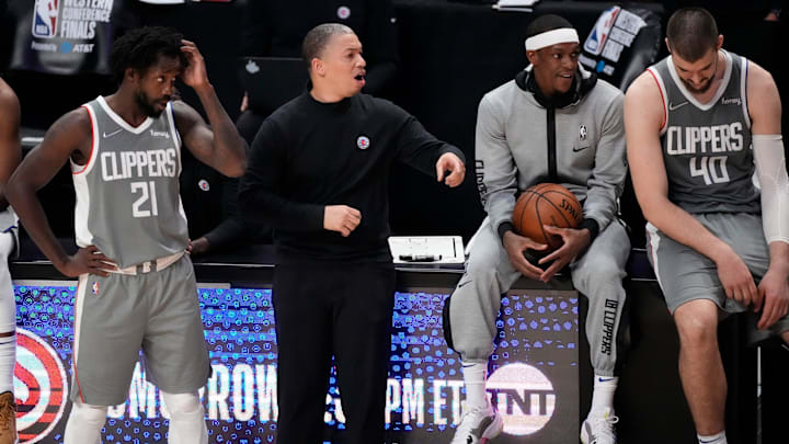 Jun 26, 2021; Los Angeles, California, USA; LA Clippers guard Patrick Beverley (21) and head coach Trronn Lue, and Rajon Rondo and center Ivica Zubac (40) reactsduring the closing seconds of the Clippers loss to the Phoenix Suns in game four of the Western Conference Finals for the 2021 NBA Playoffs at Staples Center. Mandatory Credit: Robert Hanashiro-Imagn Images