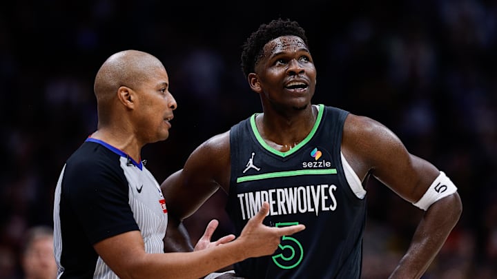 Apr 1, 2025; Denver, Colorado, USA; Minnesota Timberwolves guard Anthony Edwards (5) talks with referee CJ Washington (12) in overtime against the Denver Nuggets at Ball Arena. Mandatory Credit: Isaiah J. Downing-Imagn Images