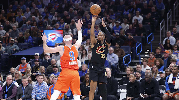 Jan 16, 2025; Oklahoma City, Oklahoma, USA; Cleveland Cavaliers forward Isaac Okoro (35) shoots and makes a three point basket as Oklahoma City Thunder guard Alex Caruso (9) defends during the second quarter at Paycom Center. Mandatory Credit: Alonzo Adams-Imagn Images Jan 16, 2025; Oklahoma City, Oklahoma, USA; Cleveland Cavaliers forward Isaac Okoro (35) shoots and makes a three point basket as Oklahoma City Thunder guard Alex Caruso (9) defends during the second quarter at Paycom Center. Mandatory Credit: Alonzo Adams-Imagn Images
