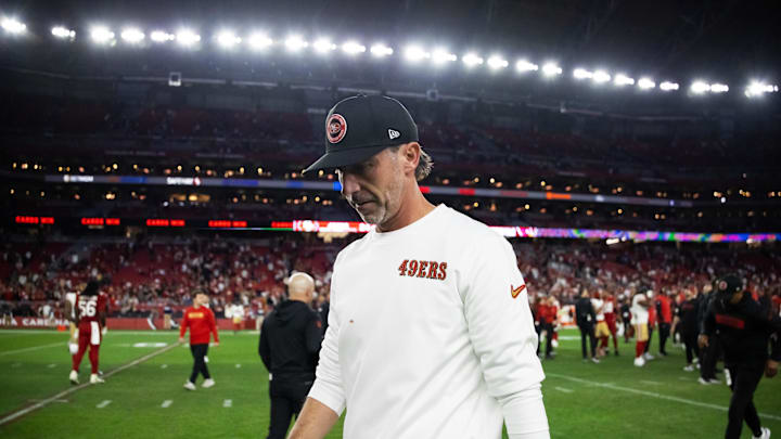 Kyle Shanahan walks off the field after a loss to the Cardinals.