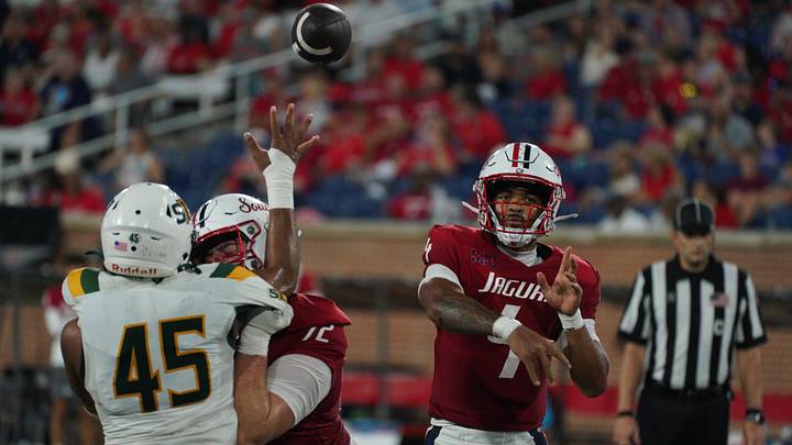 Sep 5, 2026; Mobile, Alabama, USA; South Alabama Jaguars quarterback Bishop Davenport (4) throws a pass as offensive lineman Ethan Hubbard (middle) blocks against Southeastern Louisiana Lions defensive lineman Khalid Moore (45) during the second quarter at Hancock Whitney Stadium. Mandatory Credit: Glenn Andrews-Imagn Images Sep 5, 2026; Mobile, Alabama, USA; South Alabama Jaguars quarterback Bishop Davenport (4) throws a pass as offensive lineman Ethan Hubbard (middle) blocks against Southeastern Louisiana Lions defensive lineman Khalid Moore (45) during the second quarter at Hancock Whitney Stadium. Mandatory Credit: Glenn Andrews-Imagn Images
