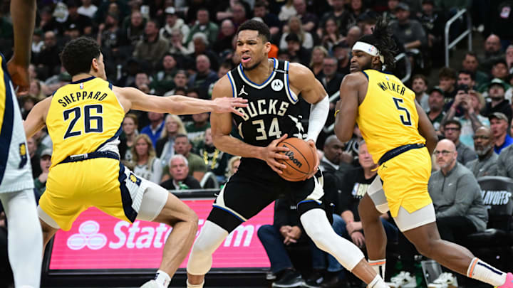 Apr 27, 2025; Milwaukee, Wisconsin, USA; Milwaukee Bucks forward Giannis Antetokounmpo (34) looks for a shot against Indiana Pacers guard Ben Sheppard (26) and  forward Jarace Walker (5) in the third quarter during game four of first round for the 2024 NBA Playoffs at Fiserv Forum. Mandatory Credit: Benny Sieu-Imagn Images
