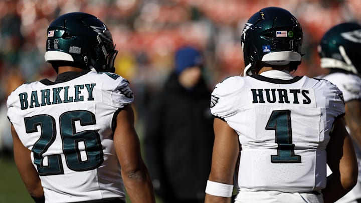 Dec 22, 2024; Landover, Maryland, USA; Philadelphia Eagles running back Saquon Barkley (26) and Eagles quarterback Jalen Hurts (1) stand on the field during warmup prior to the game against the Washington Commanders at Northwest Stadium. Mandatory Credit: Geoff Burke-Imagn Images