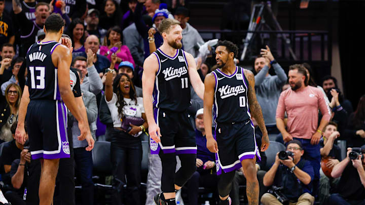 Jan 16, 2025; Sacramento, California, USA; Sacramento Kings guard Malik Monk (0) and forward Domantas Sabonis (11) celebrate after a play against the Houston Rockets during the fourth quarter at Golden 1 Center. Mandatory Credit: Sergio Estrada-Imagn Images