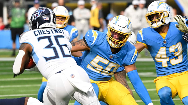 Tennessee Titans running back Julius Chestnut runs past Los Angeles Chargers linebacker Caleb Murphy.