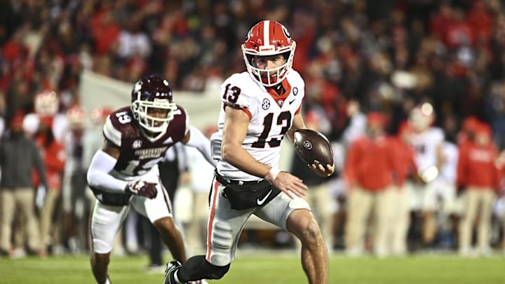 Nov 12, 2022; Starkville, Mississippi, USA; Georgia Bulldogs quarterback Stetson Bennett (13) runs the ball againstMississippi State Bulldogs safety Collin Duncan (19) during the second quarter at Davis Wade Stadium at Scott Field. Mandatory Credit: Matt Bush-Imagn Images Nov 12, 2022; Starkville, Mississippi, USA; Georgia Bulldogs quarterback Stetson Bennett (13) runs the ball againstMississippi State Bulldogs safety Collin Duncan (19) during the second quarter at Davis Wade Stadium at Scott Field. Mandatory Credit: Matt Bush-Imagn Images