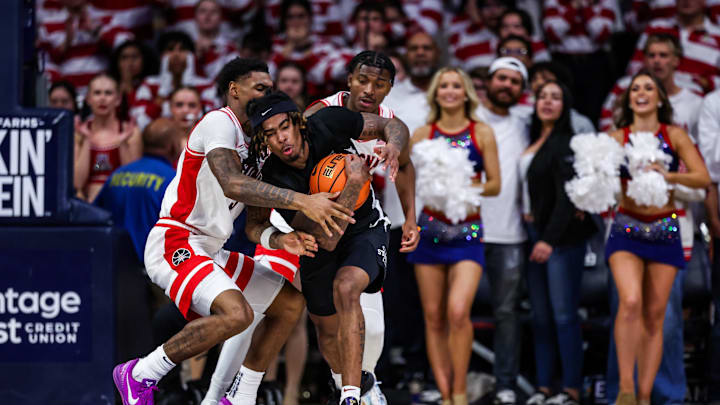 Jan 27, 2025; Tucson, Arizona, USA; Arizona Wildcats guard KJ Lewis (5) and Jaden Bradley (0) attempt to steal the ball from Iowa State Cyclones guard Keshon Gilbert (10) during overtime at McKale Center. Mandatory Credit: Aryanna Frank-Imagn Images