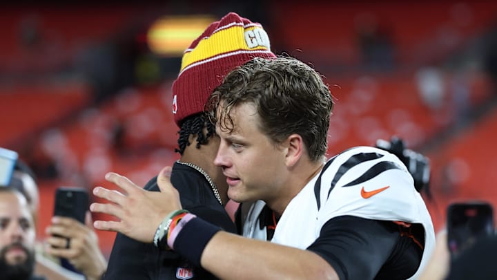 Aug 18, 2025; Landover, Maryland, USA; Cincinnati Bengals quarterback Joe Burrow (9) greets Washington Commanders quarterback Jayden Daniels (5) after their game at Northwest Stadium. Mandatory Credit: Amber Searls-Imagn Images