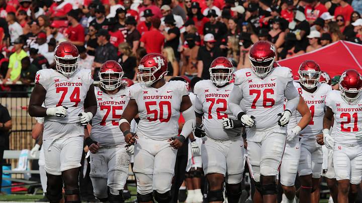 Sep 30, 2023; Lubbock, Texas, USA;  Members of the Houston Cougars offensive line run onto the field against the Texas Tech Red Raiders in the first half at Jones AT&T Stadium and Cody Campbell Field. Mandatory Credit: Michael C. Johnson-Imagn Images