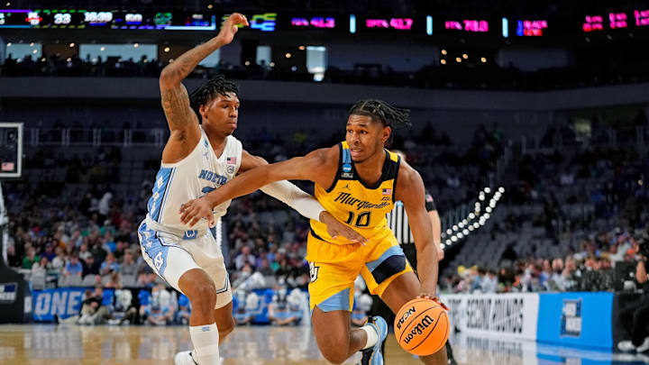 Mar 17, 2022; Fort Worth, TX, USA; Marquette Golden Eagles forward Justin Lewis (10) dribbles the ball against North Carolina Tar Heels guard Caleb Love (2) during the second half during the first round of the 2022 NCAA Tournament at Dickies Arena. Mandatory Credit: Chris Jones-Imagn Images