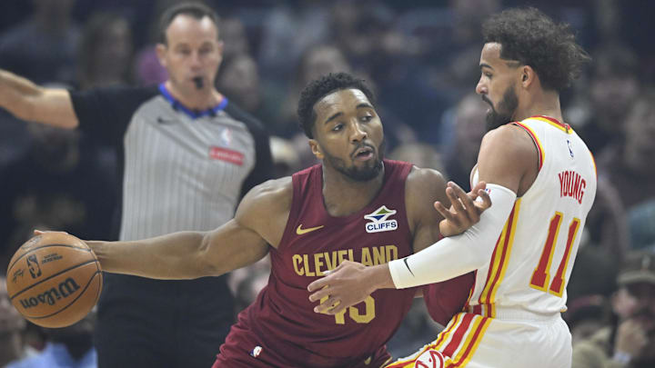 Jan 30, 2025; Cleveland, Ohio, USA; Atlanta Hawks guard Trae Young (11) defends Cleveland Cavaliers guard Donovan Mitchell (45) in the first quarter at Rocket Mortgage FieldHouse. Mandatory Credit: David Richard-Imagn Images