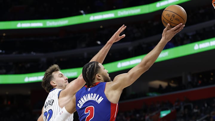 Oct 29, 2025; Detroit, Michigan, USA; Detroit Pistons guard Cade Cunningham (2) shoots on Orlando Magic forward Franz Wagner (22) in the second half at Little Caesars Arena. Mandatory Credit: Rick Osentoski-Imagn Images