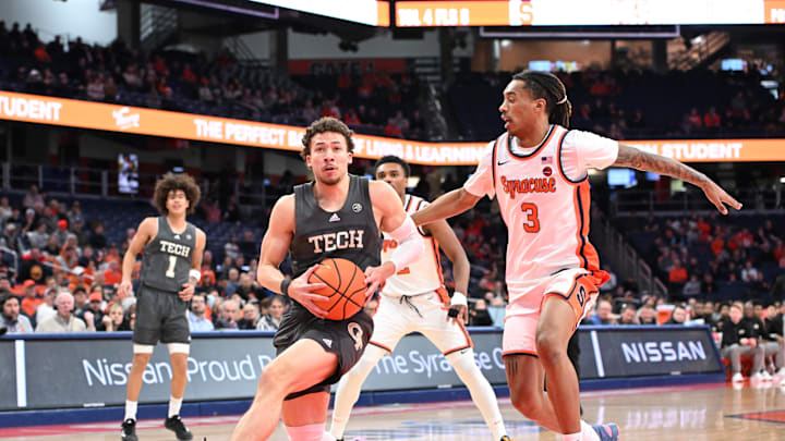 Jan 7, 2025; Syracuse, New York, USA; Georgia Tech Yellow Jackets guard Lance Terry (0) gets ready to make a lay up with Syracuse Orange guard Lucas Taylor (3) defending in the first half at the JMA Wireless Dome. Mandatory Credit: Mark Konezny-Imagn Images