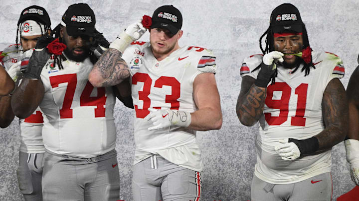 Jan 1, 2025; Pasadena, CA, USA; Ohio State Buckeyes offensive lineman Donovan Jackson (74), Ohio State  defensive end Jack Sawyer (33) and defensive tackle Tyleik Williams (91) deliberate defeating the Oregon Ducks at Rose Bowl Stadium.