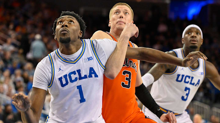 Feb 21, 2026; Los Angeles, California, USA; UCLA forward Xavier Booker (1) tangles up with Illinois forward Ben Humrichous (3) under the basket during the second half at Pauley Pavilion presented by Wescom Financial. Mandatory Credit: Robert Hanashiro-Imagn Images