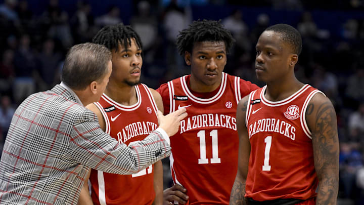 Arkansas Razorbacks head coach John Calipari talks with guard D.J. Wagner (21), forward Karter Knox (11), and guard Johnell Davis (1) against the Mississippi Rebels during the second half at Bridgestone Arena. 