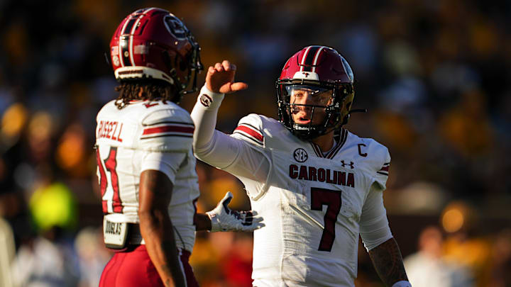 Oct 21, 2023; Columbia, Missouri, USA; South Carolina Gamecocks quarterback Spencer Rattler (7) talks to wide receiver Tyshawn Russell (21) during the second half against the Missouri Tigers at Faurot Field at Memorial Stadium. Mandatory Credit: Jay Biggerstaff-Imagn Images