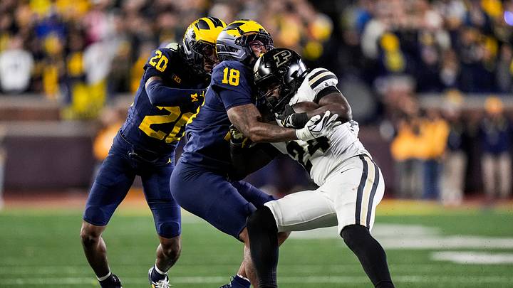 Michigan linebacker Troy Bowles (18) tackles Purdue running back Malachi Thomas (24) during the second half at Michigan Stadium in Ann Arbor on Saturday, November 1, 2025.