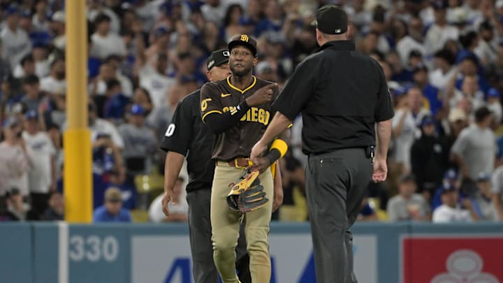 Oct 6, 2024; Los Angeles, California, USA; San Diego Padres outfielder Jurickson Profar (10) talks to umpires in the seventh inning against the Los Angeles Dodgers during game two of the NLDS for the 2024 MLB Playoffs at Dodger Stadium. Mandatory Credit: Jayne Kamin-Oncea-Imagn Images