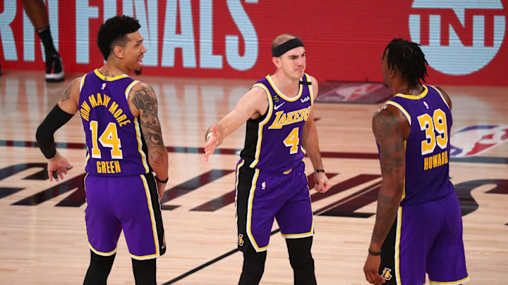 Sep 26, 2020; Lake Buena Vista, Florida, USA; Los Angeles Lakers guard Alex Caruso (4) celebrates with guard Danny Green (14) and center Dwight Howard (39) against the Denver Nuggets during the fourth quarter in game five of the Western Conference Finals of the 2020 NBA Playoffs at AdventHealth Arena. Mandatory Credit: Kim Klement-Imagn Images