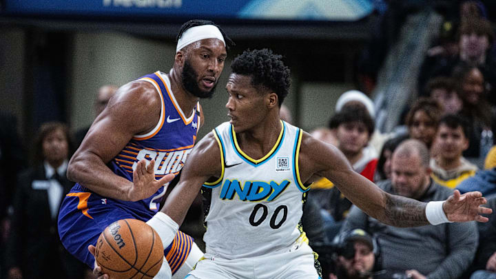 Jan 4, 2025; Indianapolis, Indiana, USA; Indiana Pacers guard Bennedict Mathurin (00) dribbles the ball against Phoenix Suns forward Josh Okogie (2) in the first half at Gainbridge Fieldhouse. Mandatory Credit: Trevor Ruszkowski-Imagn Images