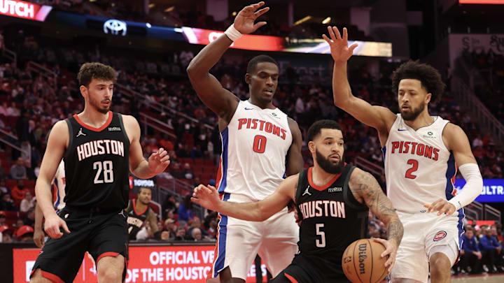 Jan 20, 2025; Houston, Texas, USA; Houston Rockets guard Fred VanVleet (5) is guarded by Detroit Pistons center Jalen Duren (0) and guard Cade Cunningham (2)  in the first quarter at Toyota Center. Mandatory Credit: Thomas Shea-Imagn Images