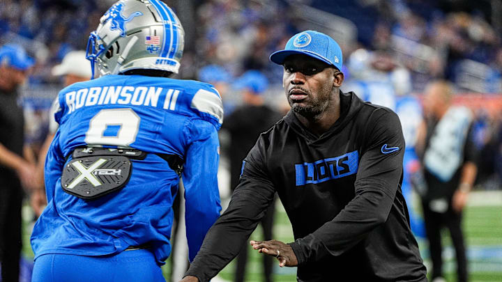 Detroit Lions assistant head coach and running backs coach Scottie Montgomery warms up with wide receiver Allen Robinson (8) before the game between Detroit Lions and Chicago Bears at Ford Field in Detroit on Thursday, Nov. 28, 2024.