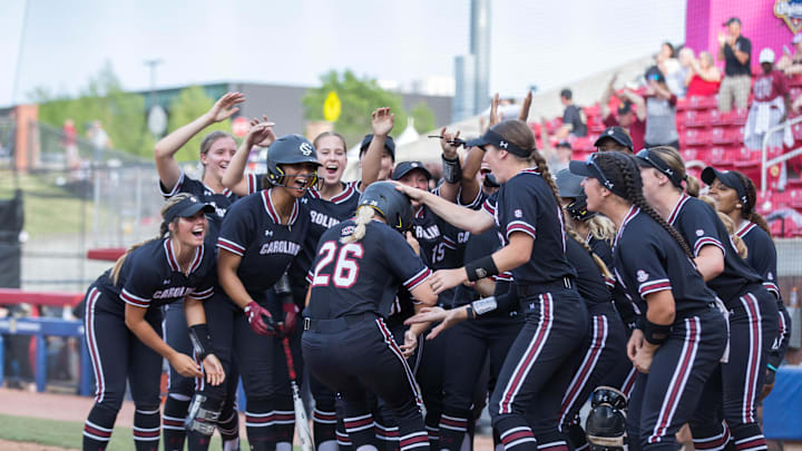 May 11, 2023; Fayetteville, AK, USA;  South Carolina Gamecocks infielder Riley Blampied (26) is swarmed by her team after hitting a home run during a quarterfinal game against the Georgia Bulldogs in the SEC Softball Tournament. Mandatory Credit: Brett Rojo-Imagn Images