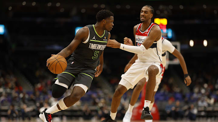 Jan 13, 2025; Washington, District of Columbia, USA; Minnesota Timberwolves guard Anthony Edwards (5) drives to the basket as Washington Wizards forward Alexandre Sarr (20) defends in the third quarter  at Capital One Arena. Mandatory Credit: Geoff Burke-Imagn Images