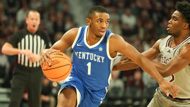 Jan 11, 2025; Starkville, Mississippi, USA; Kentucky Wildcats guard Lamont Butler (1) drives to the basket against Mississippi State Bulldogs guard Josh Hubbard (right) during the first half at Humphrey Coliseum. Mandatory Credit: Wesley Hale-Imagn Images