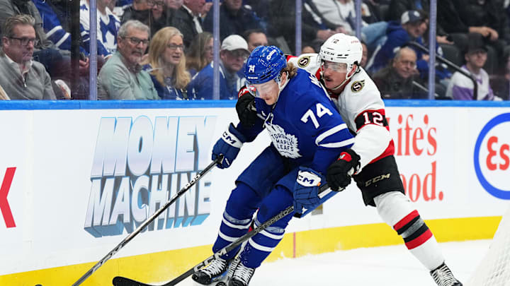 Nov 12, 2024; Toronto, Ontario, CAN; Toronto Maple Leafs center Bobby McMann (74) battles for the puck with Ottawa Senators center Shane Pinto (12) during the third period at Scotiabank Arena. Mandatory Credit: Nick Turchiaro-Imagn Images