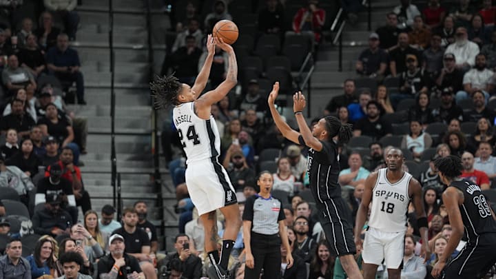 Mar 4, 2025; San Antonio, Texas, USA;  San Antonio Spurs guard Devin Vassell (24) shoots over Brooklyn Nets forward Ziaire Williams (8) in the second half at Frost Bank Center. Mandatory Credit: Daniel Dunn-Imagn Images