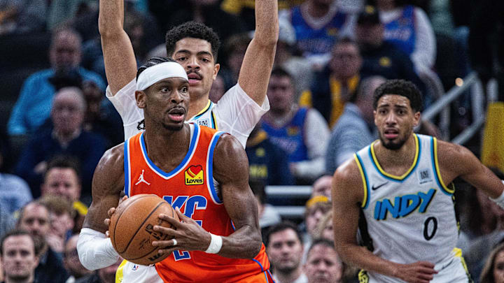 Dec 26, 2024; Indianapolis, Indiana, USA; Oklahoma City Thunder guard Shai Gilgeous-Alexander (2) looks to pass the ball while Indiana Pacers guard Ben Sheppard (26) defends in the first half at Gainbridge Fieldhouse. Mandatory Credit: Trevor Ruszkowski-Imagn Images