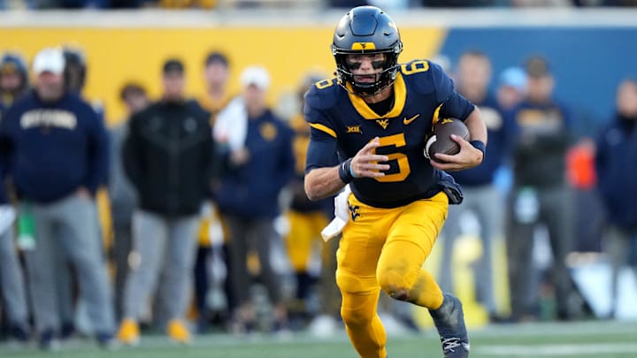 West Virginia Mountaineers quarterback Garrett Greene (6) carries the ball on a touchdown run in the